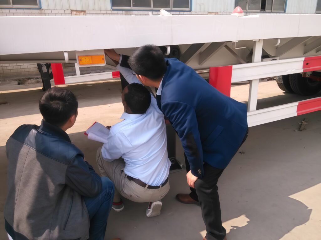 Nigerian customer inspects flatbed semi-trailer